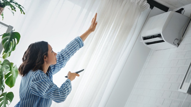 woman using reverse cycle air conditioner